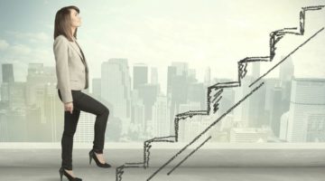 business woman climbing stairs over city success concept | 59 Work Tips to Be Better At Your Job  https://positiveroutines.com/best-work-tips/