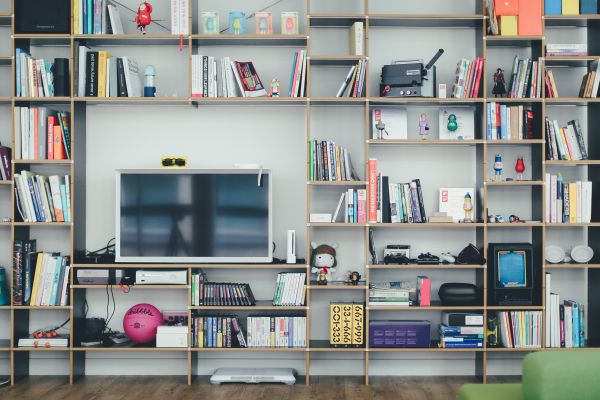 desk within shelves | The Best Decluttering Tips for a Productive Workspace https://positiveroutines.com/decluttering-tips/