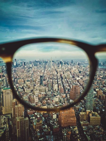 eyeglasses looking at city from above focus concept | How to Use Single-Tasking To Skyrocket Your Productivity  https://positiveroutines.com/single-tasking-productivity/