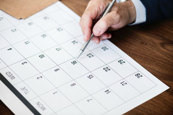 man filling out calendar | Yes, You Can Stop Procrastinating. Here's How. https://positiveroutines.com/stop-procrastinating/