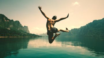 man jumping in water | New Science Reveals 5 Secrets That Will Make You Happy