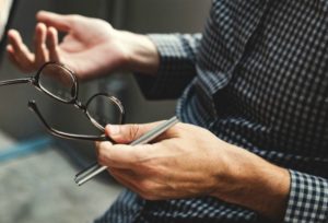 man with open hands holding glasses | Why is Finding Meaning In Life and Work So Important? https://positiveroutines.com/finding-meaning/ 