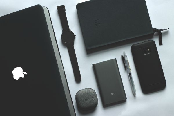 organized black office materials phone laptop on white table | How to Make Being a Perfectionist Work For You  https://positiveroutines.com/being-a-perfectionist/
