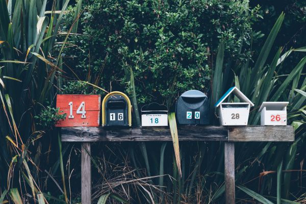 various mailboxes lined up outside | The Best Decluttering Tips for a Productive Workspace https://positiveroutines.com/decluttering-tips/