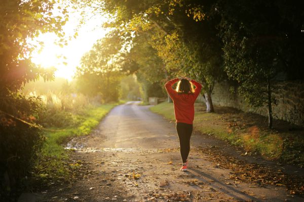 woman stretching after run on path as sun rises | This Is the Morning Routine That Will Make You Successful