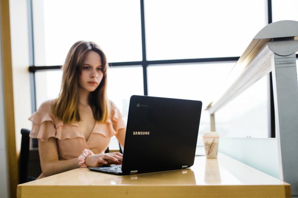woman working on laptop at desk | One of the Best Benefits of Napping? Increased Productivity https://positiveroutines.com/productivity-benefits-of-napping/