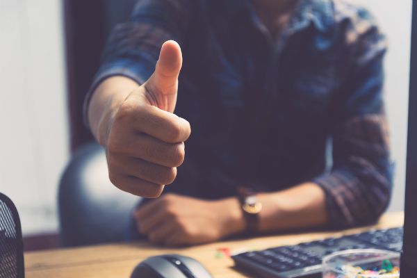 close up of man giving thumbs up | How to Handle Job Burnout, Even If You Love Your Work https://positiveroutines.com/job-burnout-guide/