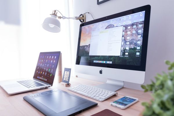 desk with laptop mac desktop phone tablet | How to Use Single-Tasking To Skyrocket Your Productivity  https://positiveroutines.com/single-tasking-productivity/