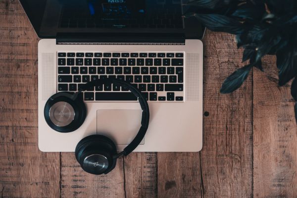 headphones sitting on laptop | Can You Use Music For Productivity Gains? https://positiveroutines.com/music-for-productivity/
