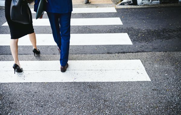 business man and woman crossing pedestrian lane | In Time for the Holidays: How to Take Breaks Effectively  https://positiveroutines.com/how-to-take-breaks/