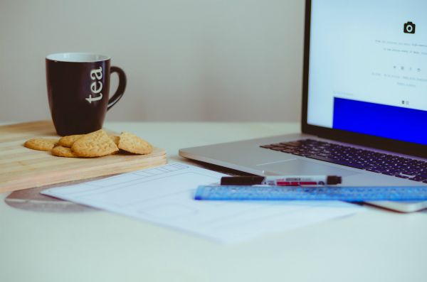 empty desk with tea mug and cookies | These 9 Positive Habits Will Make Your Life Better https://positiveroutines.com/positive-habits/