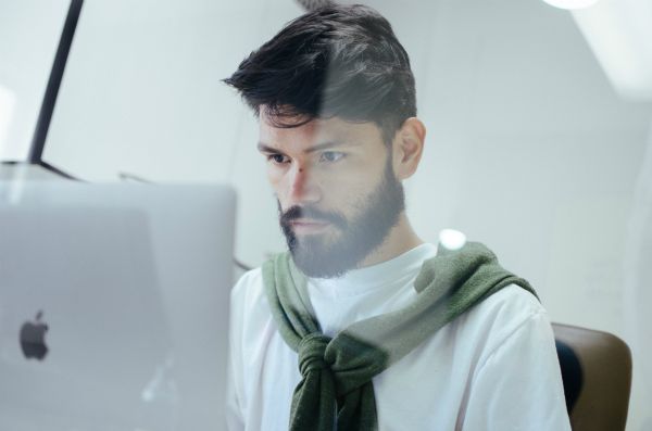 man concentrating on laptop | For Ultimate Productivity, Manage Your Energy, Not Your Time  https://positiveroutines.com/manage-your-energy-not-your-time/ 