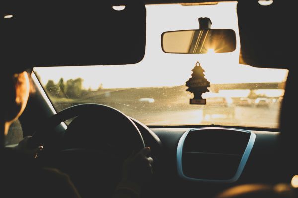 man driving in the sun | How to Make the Most of Your Commute to Work https://positiveroutines.com/commute-to-work-tips/