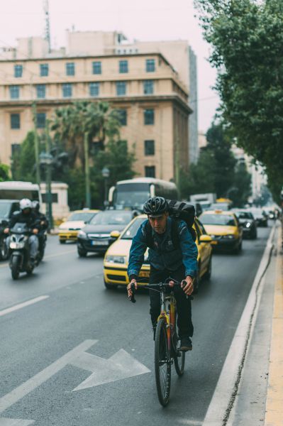 man riding bike to work | How to Make the Most of Your Commute to Work https://positiveroutines.com/commute-to-work-tips/