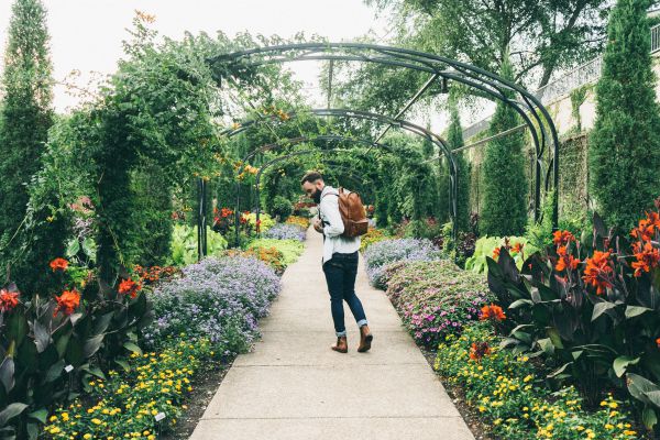 man walking through garden smiling | In Time for the Holidays: How to Take Breaks Effectively  https://positiveroutines.com/how-to-take-breaks/