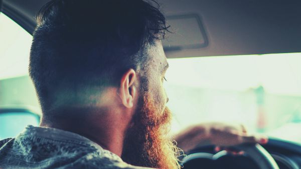 man with big beard inside car | How to Make the Most of Your Commute to Work https://positiveroutines.com/commute-to-work-tips/