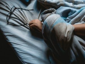 person sleeping with glasses on bed | No Distractions: 5 Ways to Focus This Fall