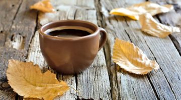 red cup of coffee with leaves outside fall concept | 5 Morning Routine Ideas to Make You Scarily Successful