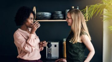 two diverse women standing at coffee machine taking a break at work | In Time for the Holidays: How to Take Breaks Effectively  https://positiveroutines.com/how-to-take-breaks/