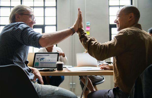 two men in office giving high fives | 5 Morning Routine Ideas to Make You Scarily Successful