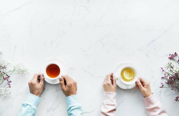 two people holding mugs of tea | In Time for the Holidays: How to Take Breaks Effectively  https://positiveroutines.com/how-to-take-breaks/