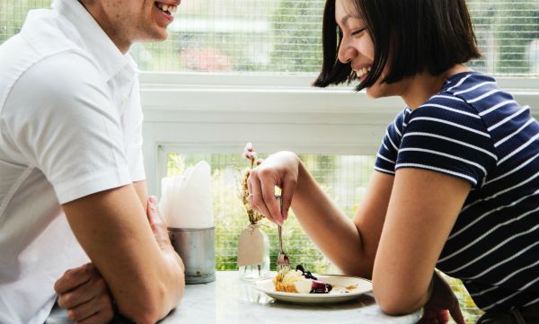 two people smiling while eating dessert | These 9 Positive Habits Will Make Your Life Better https://positiveroutines.com/positive-habits/