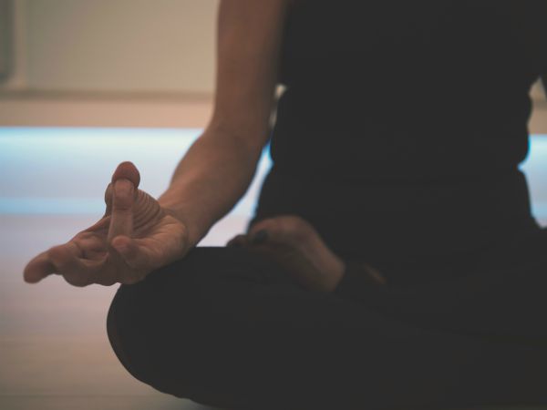 woman meditating | How to Make the Most of Your Commute to Work https://positiveroutines.com/commute-to-work-tips/