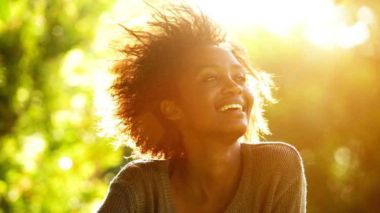 woman smiling in sunlight | These 9 Positive Habits Will Make Your Life Better https://positiveroutines.com/positive-habits/