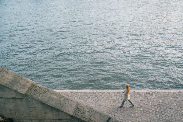woman walking by ocean | These 9 Positive Habits Will Make Your Life Better https://positiveroutines.com/positive-habits/