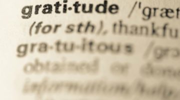 gratitude in the dictionary with words blurred out | How to Practice Gratitude With Us This November  https://positiveroutines.com/practice-gratitude/