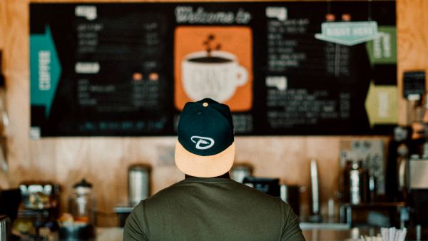 man looking at coffee menu | This Is How To Express Gratitude https://positiveroutines.com/express-gratitude/
