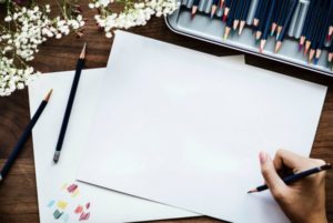 person drawing with colored pencil on blank paper | 5 Simple Steps to Feeling Grateful Right Now https://positiveroutines.com/feeling-grateful/