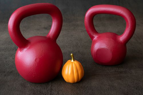 red kettlebells on brown fabric with pumpkin | 67 Healthy Mind and Body Tips to Last You All Winter https://positiveroutines.com/healthy-mind-and-body-tips/