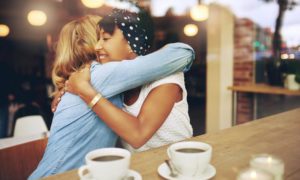 two women hugging at coffee shop | This Is How To Express Gratitude https://positiveroutines.com/express-gratitude/