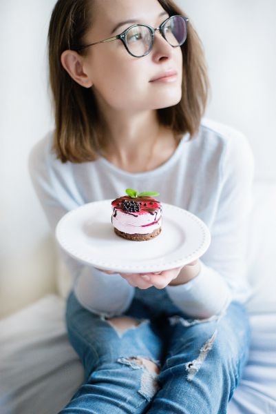 woman looking sideways holding cake | 5 Simple Steps to Feeling Grateful Right Now https://positiveroutines.com/feeling-grateful/