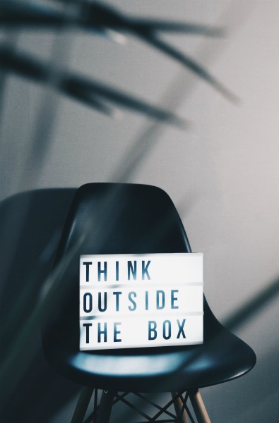 black chair with sign that reads think outside the box | The Unmistakable Magic of The 4 Day Week https://positiveroutines.com/four-day-week/