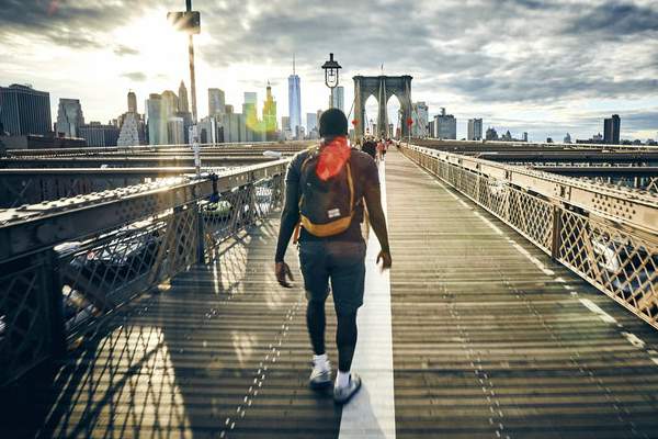 male walking on bridge in city | A Healthy Morning Routine For The Best 2019 https://positiveroutines.com/healthy-morning-routine/