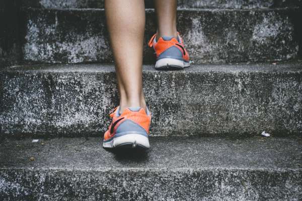 orange and grey sneakers climbing stairs | A Healthy Morning Routine For The Best 2019 https://positiveroutines.com/healthy-morning-routine/