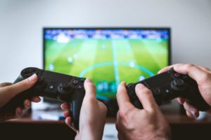 two people playing video games | The Happiest Stories of 2018 to Get You in The Spirit https://positiveroutines.com/happiest-stories/