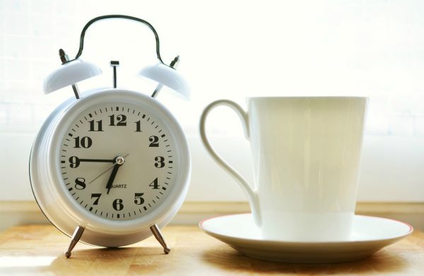vintage white alarm clock on table beside white mug | A Healthy Morning Routine For The Best 2019 https://positiveroutines.com/healthy-morning-routine/