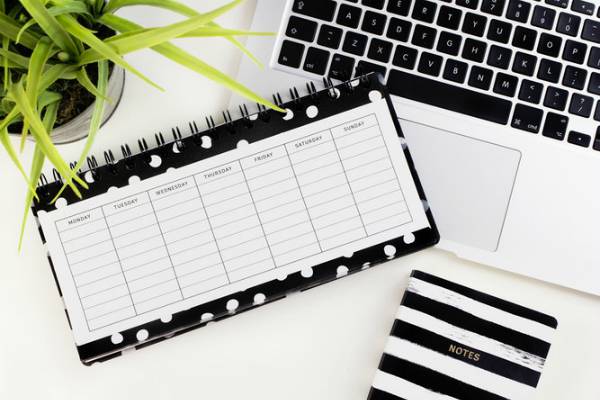 blank polka dotted weekly planner on desk | Starting a Workout Routine? Here's How to Make it Happen https://positiveroutines.com/starting-a-workout-routine/