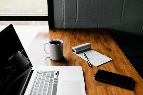 clean workspace with laptop notebook and smartphone | Productive Procrastination Exists. Here's How To Do It. https://positiveroutines.com/productive-procrastination/
