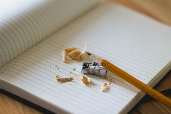 freshly sharpened pencil and shavings in open notebook | Productive Procrastination Exists. Here's How To Do It. https://positiveroutines.com/productive-procrastination/
