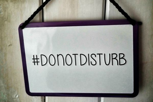 hanging do not disturb sign | 9 Ways to Improve Focus in a Distracted Environment https://positiveroutines.com/improve-focus/