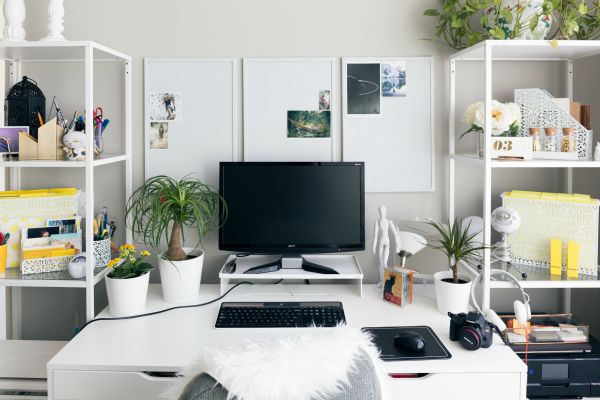 home workspace with desktop computer and bookshelves | How to Work Remotely + Why You Should Try It This Year https://positiveroutines.com/how-to-work-remotely/