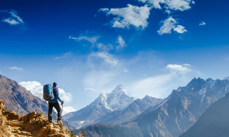 male hiker overlooking mountains | 7 Ways to Crush Your LifeGoals This Year https://positiveroutines.com/crush-lifegoals/