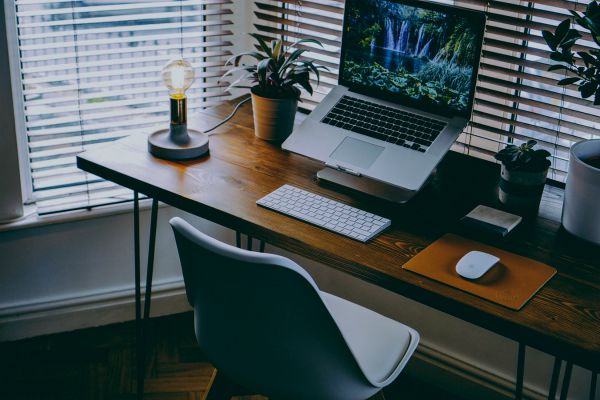 organized home office space with natural light | The Best Tips for Working Remotely When You're Outgoing, Anxious, and More https://positiveroutines.com/tips-for-working-remotely/