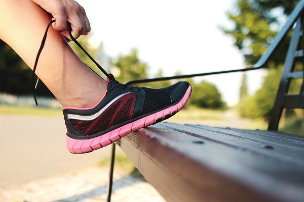 sneaker being tied on park bench | Starting a Workout Routine? Here's How to Make it Happen https://positiveroutines.com/starting-a-workout-routine/