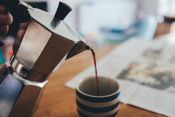coffee being poured into blue striped mug | 11 Things You Need to Have a Productive Day https://positiveroutines.com/have-a-productive-day/