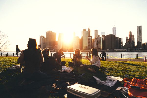 group of friends in city park sharing a picnic | 7 Easy Ways to Build a More Positive Mindset https://positiveroutines.com/positive-mindset/